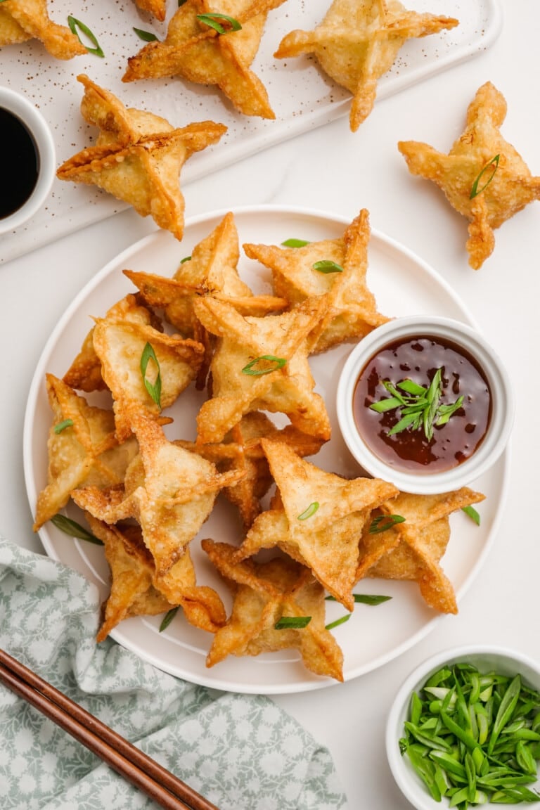 plated crab rangoon with a dish of dipping sauce