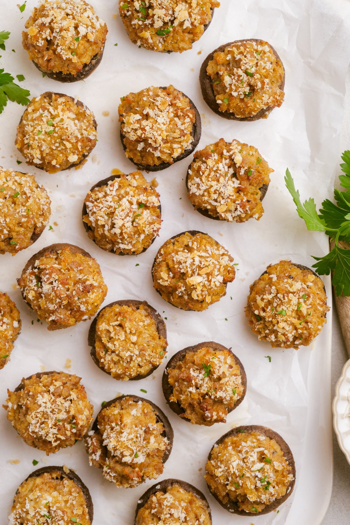 cooked sausage-stuffed-mushrooms on parchment paper