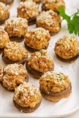 cooked sausage-stuffed-mushrooms on parchment paper