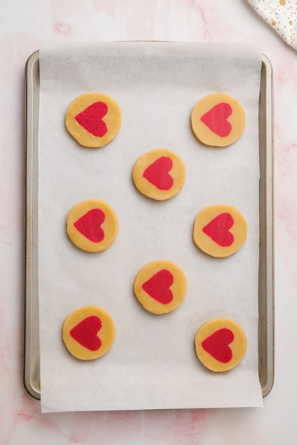 unbaked Valentine's Day cookies on baking sheet