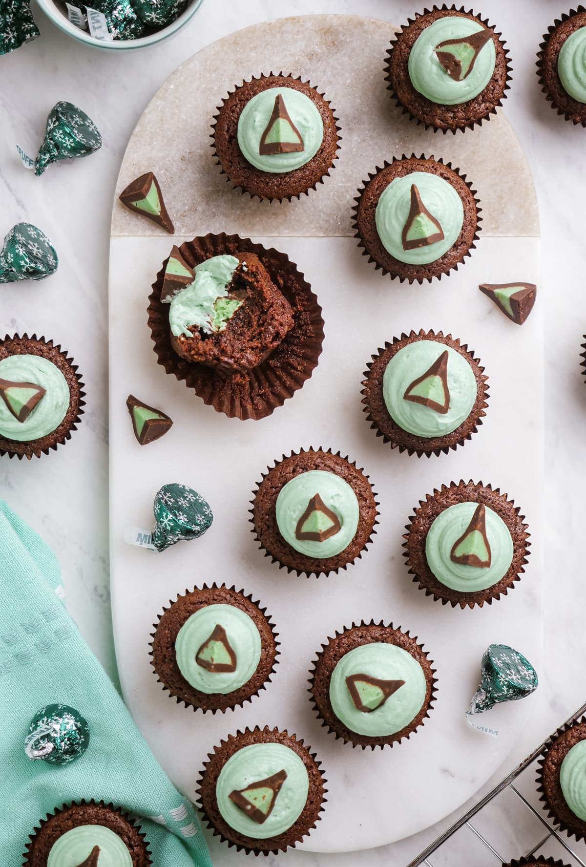 mint brownie bites on a platter, one with a bite taken out