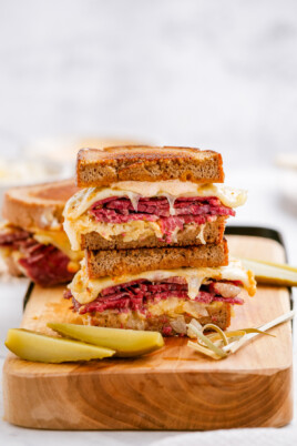 reuben sandwich stacked on cutting board