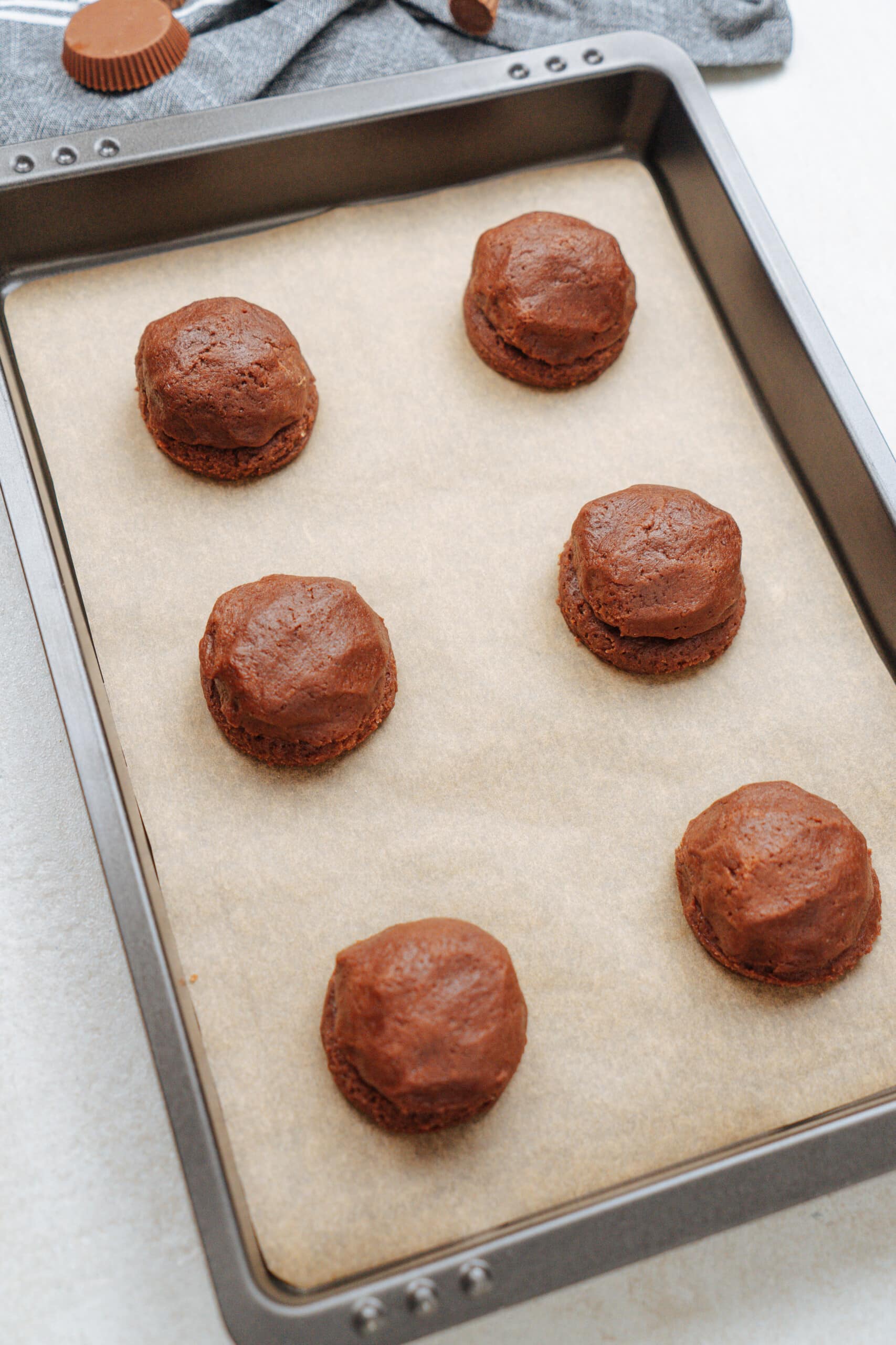 chocolate cookie dough  balls on baking sheet