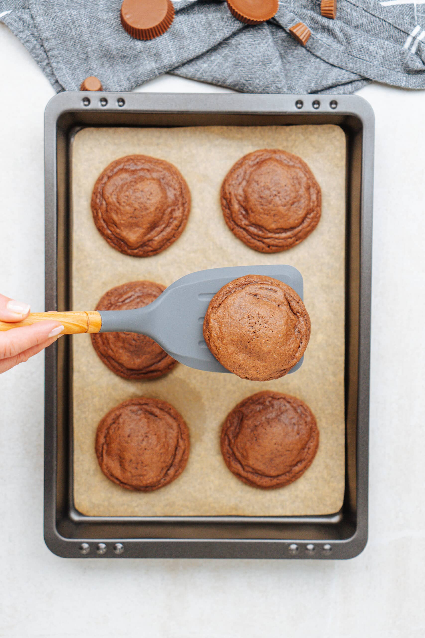 spatula removing cookie from baking sheet