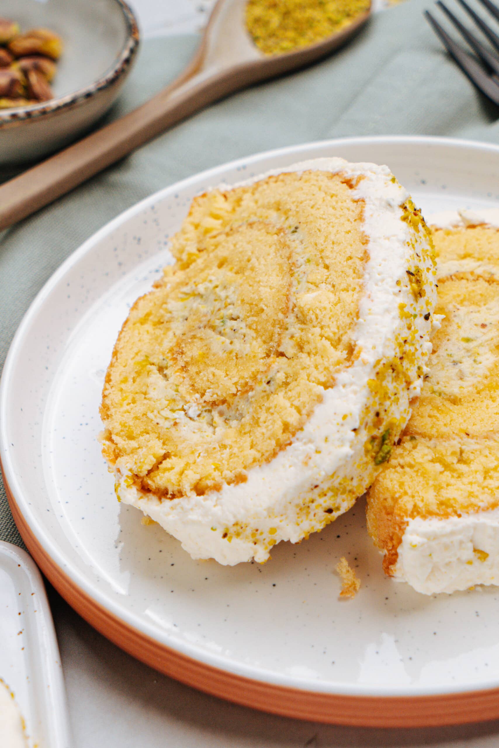 pistachio lemon roll cake slices on a plate
