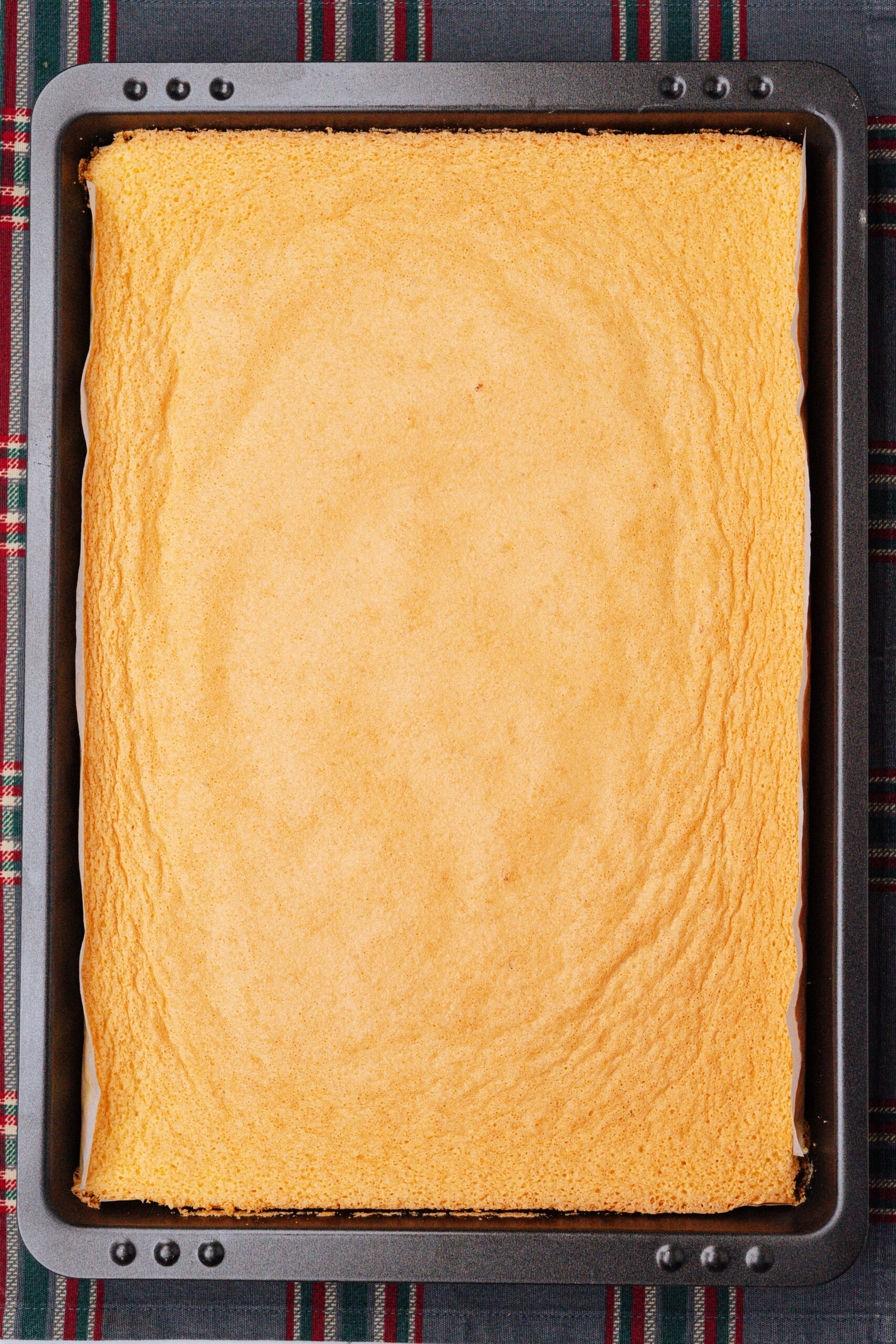 baked pistachio lemon roll cake in a pan