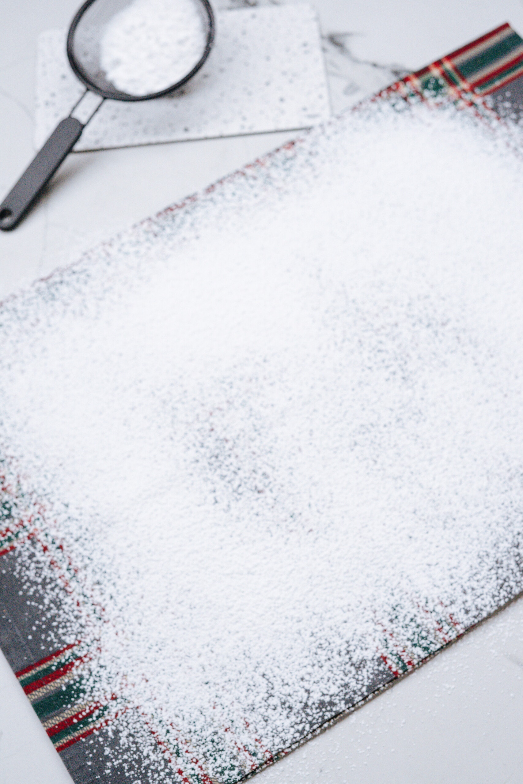 powdered sugar sprinkled across kitchen towel