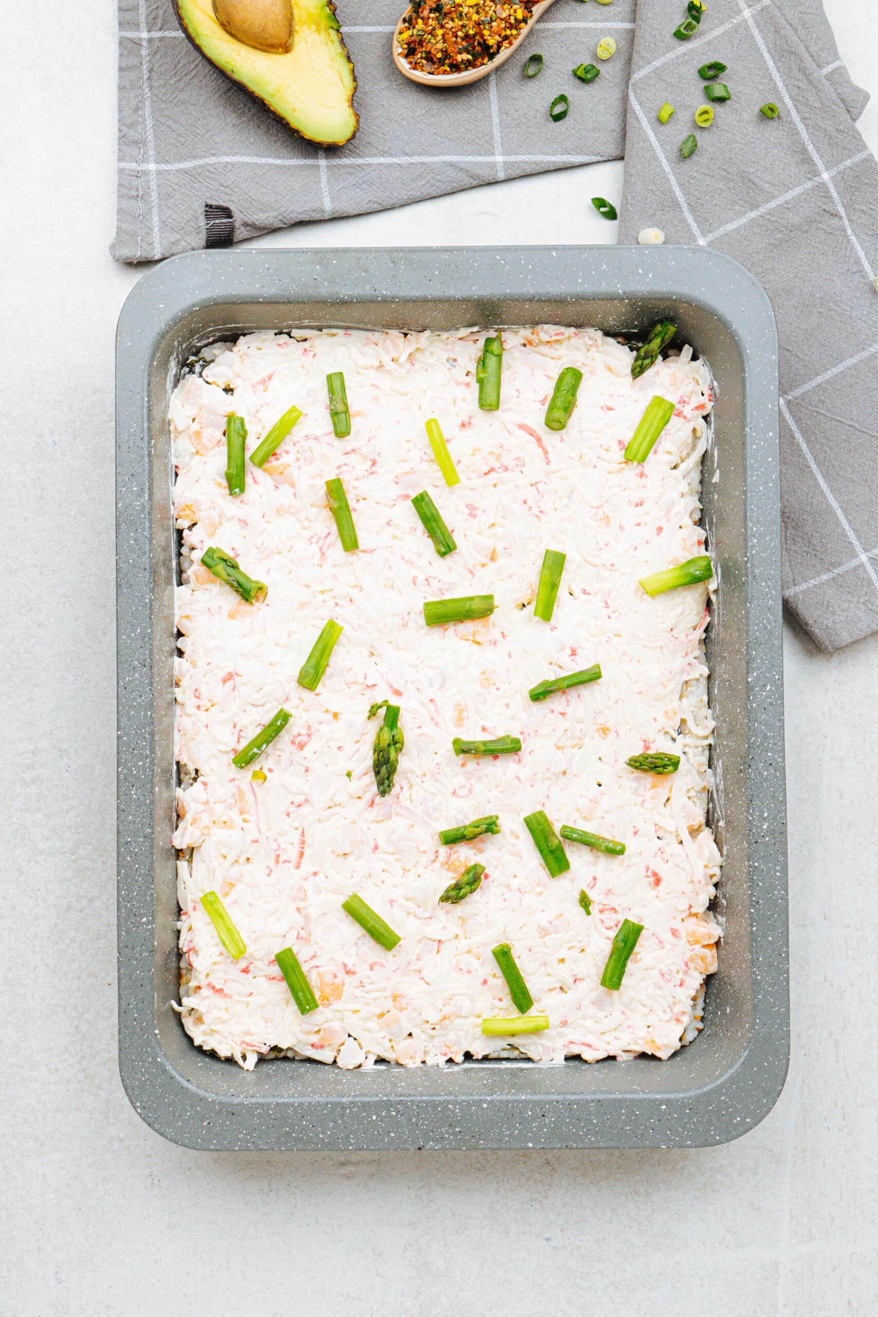 Pieces of asparagus on a sushi casserole