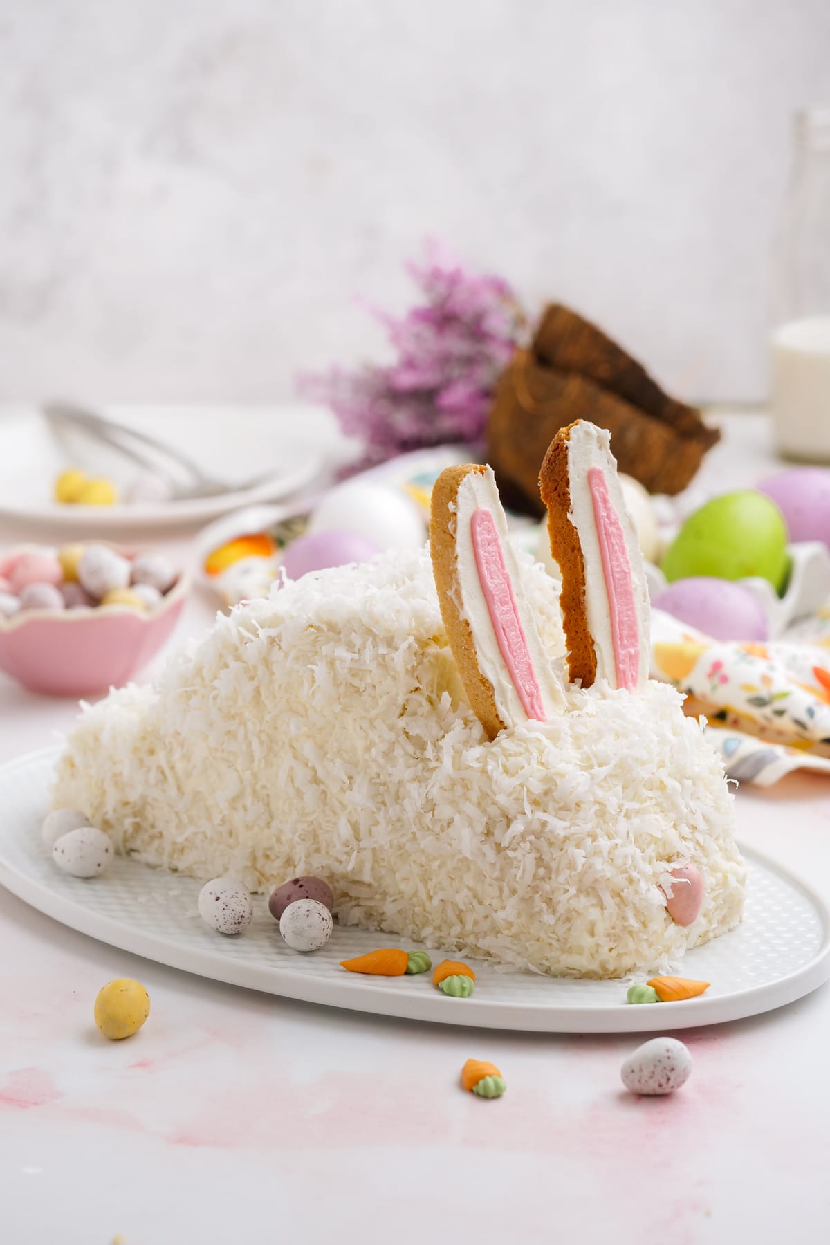 Easter bunny cake on a plate with sweets