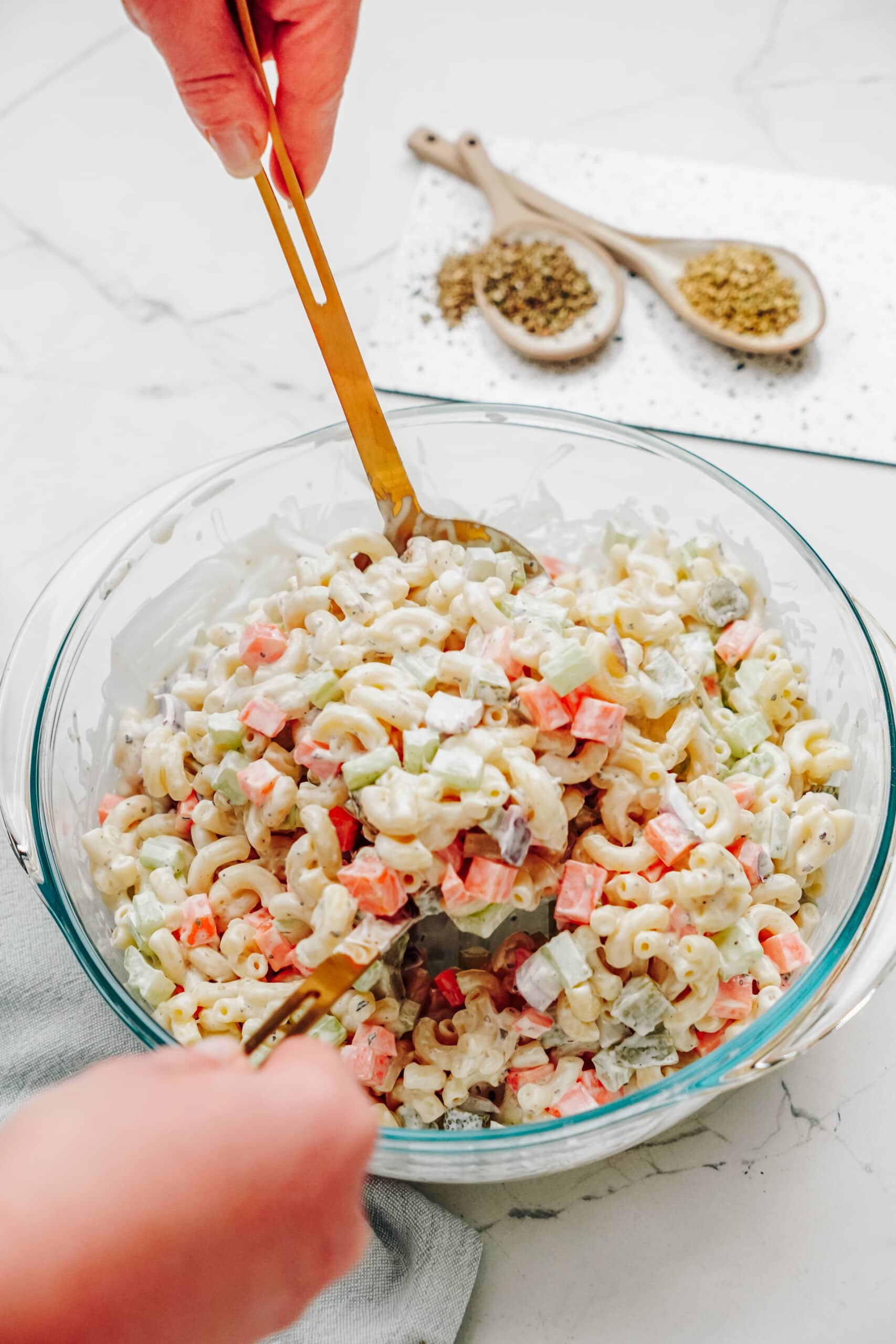 macaroni salad in a bowl with serving spoon