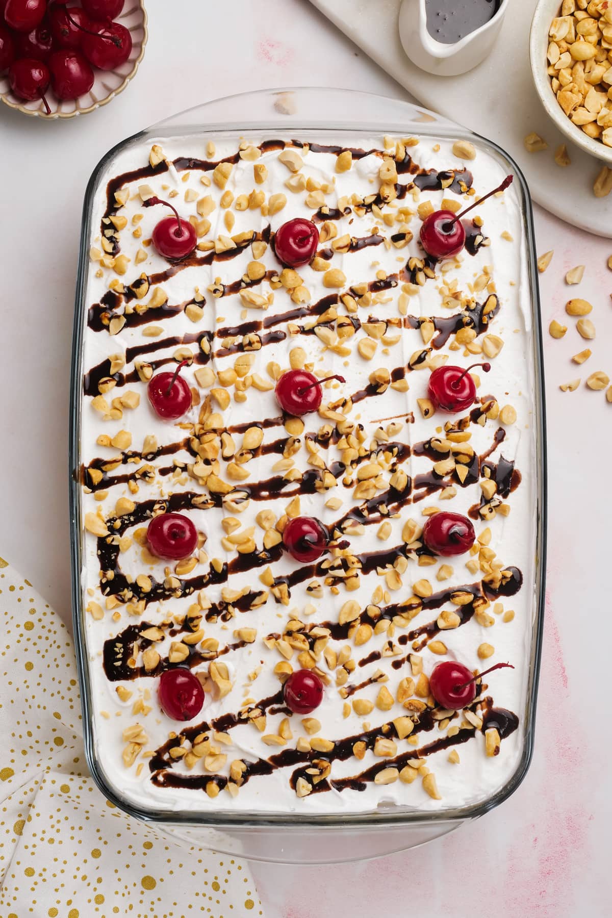 hot fudge drizzled across cake with 12 cherries on top
