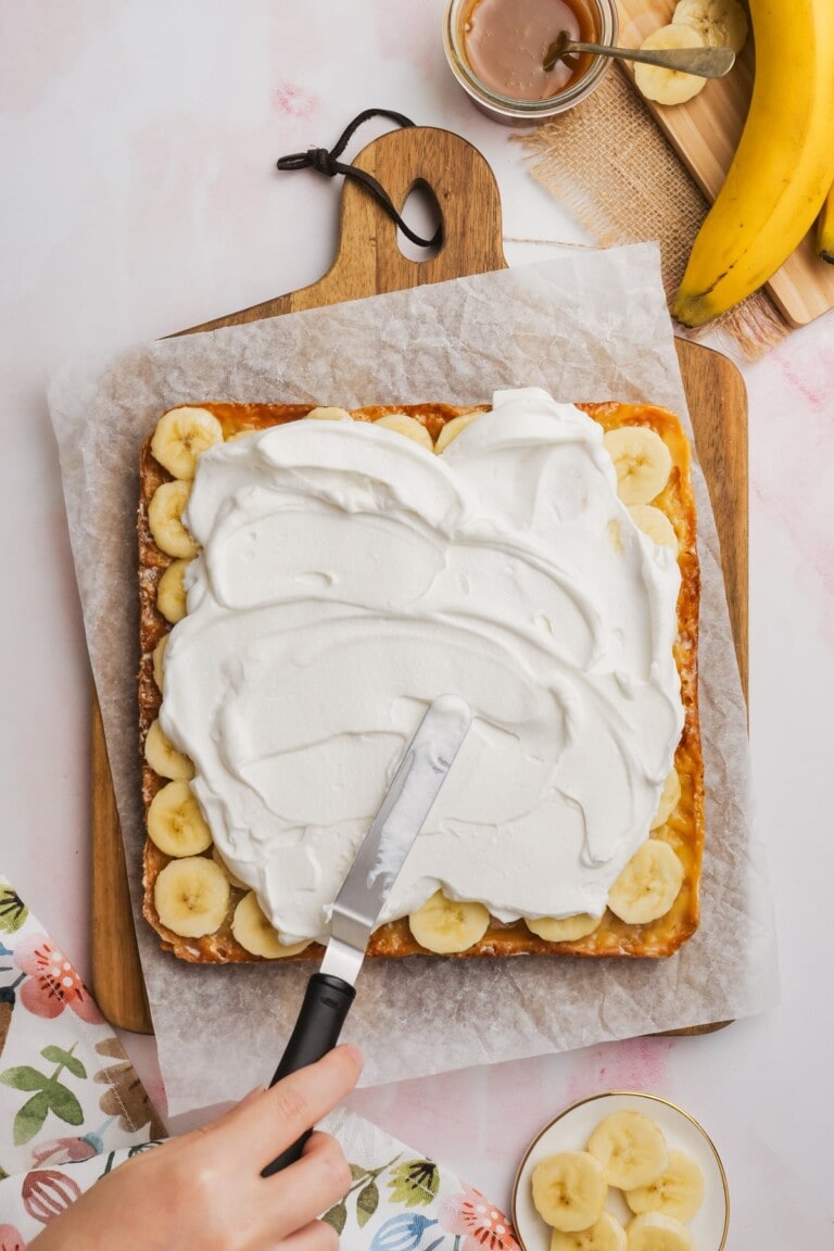 whipped cream added to the top of the banana slices