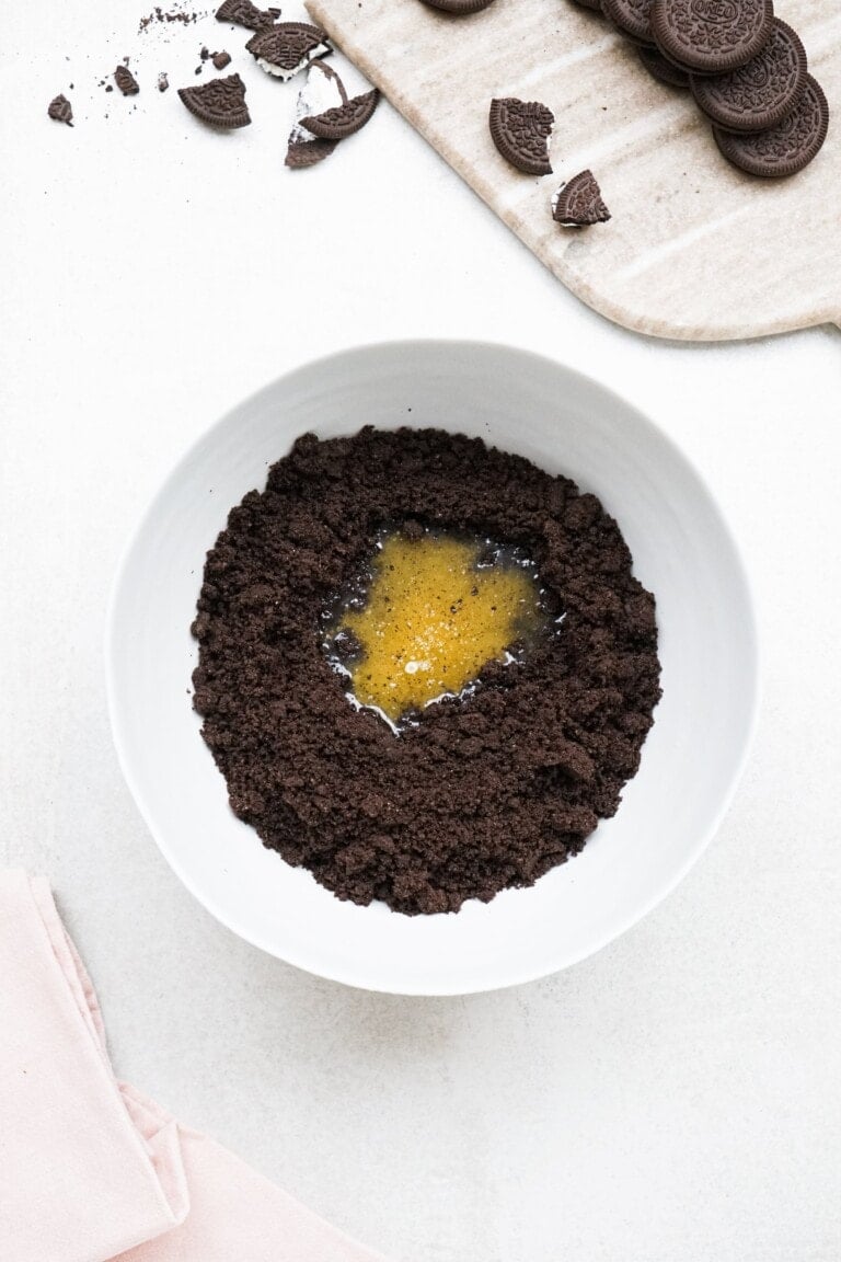 Oreo crumbles and melted butter in a bowl