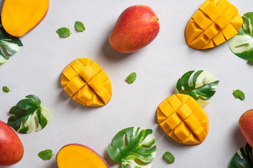 Pieces of cut and uncut mango