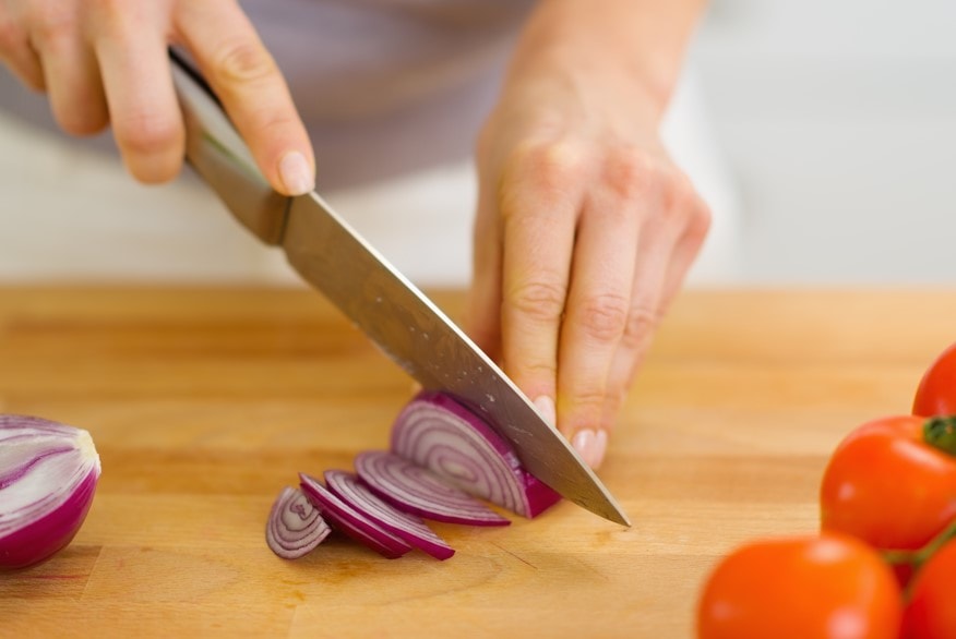 cutting an onion into strips