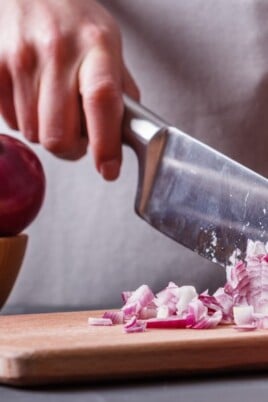 young woman cuts an onion