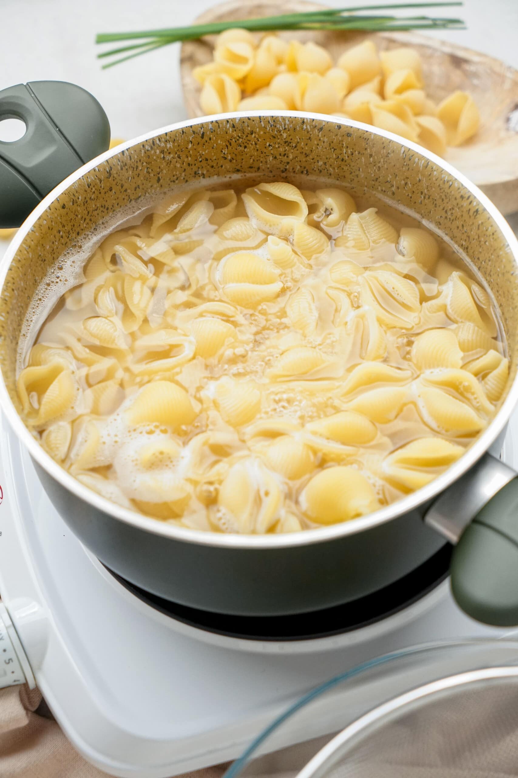 pasta shells cooking in a pot of water