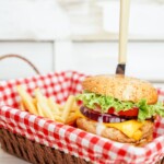 turkey burger in a red and white basket with fries