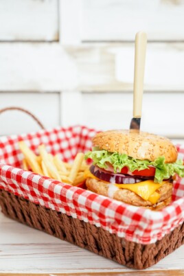turkey burger in a red and white basket with fries