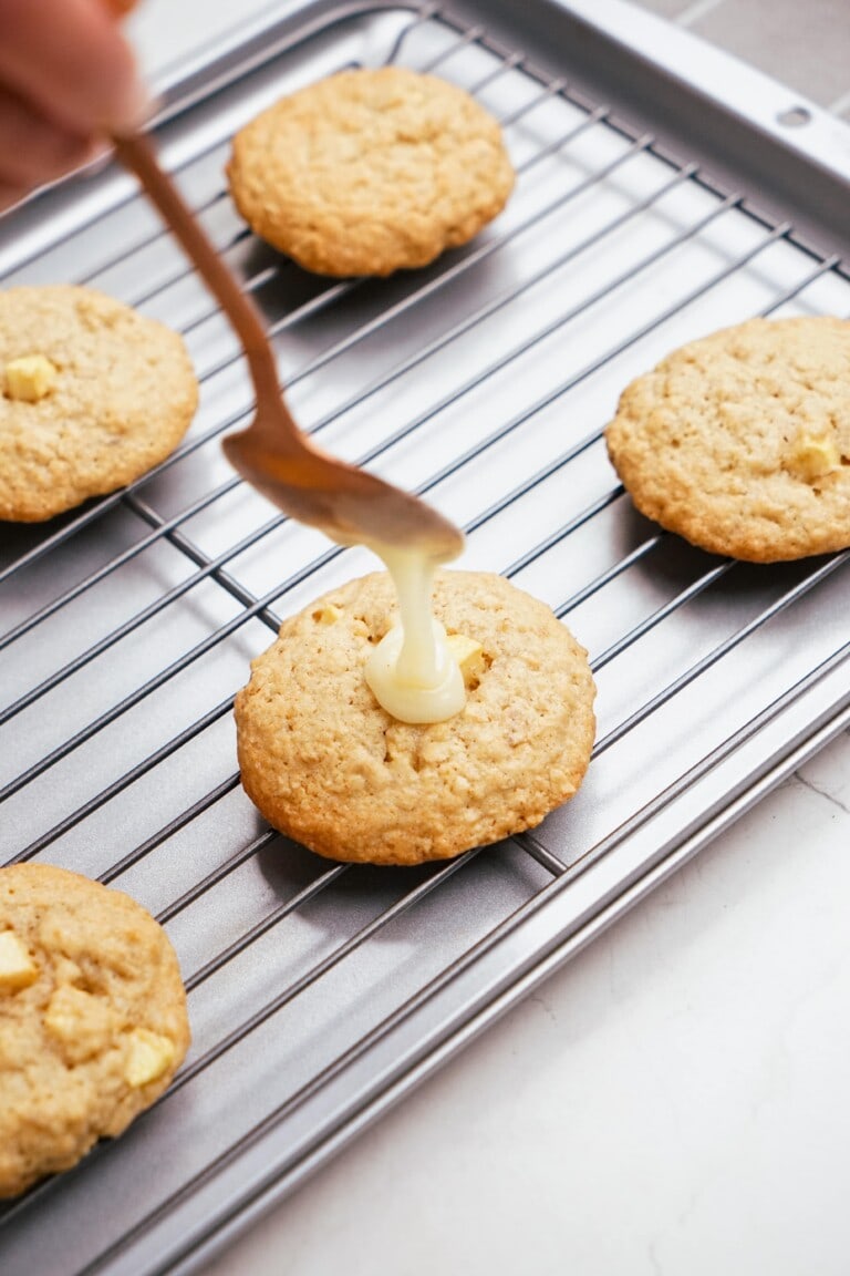 adding frosting to a cookie with a spoon