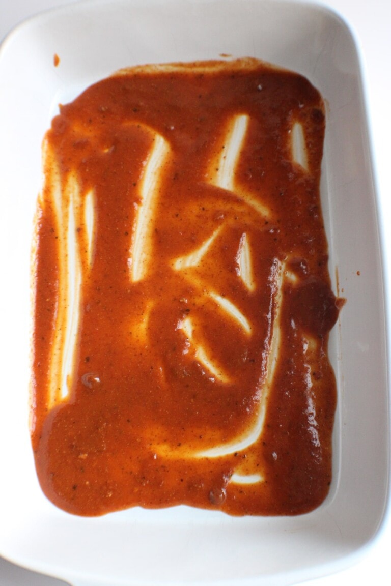 enchilada sauce in the bottom of casserole dish