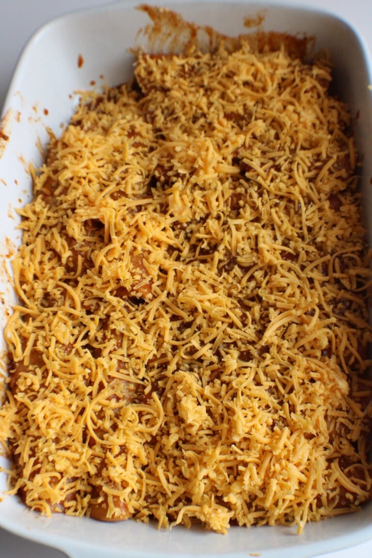 enchiladas topped with shredded cheese