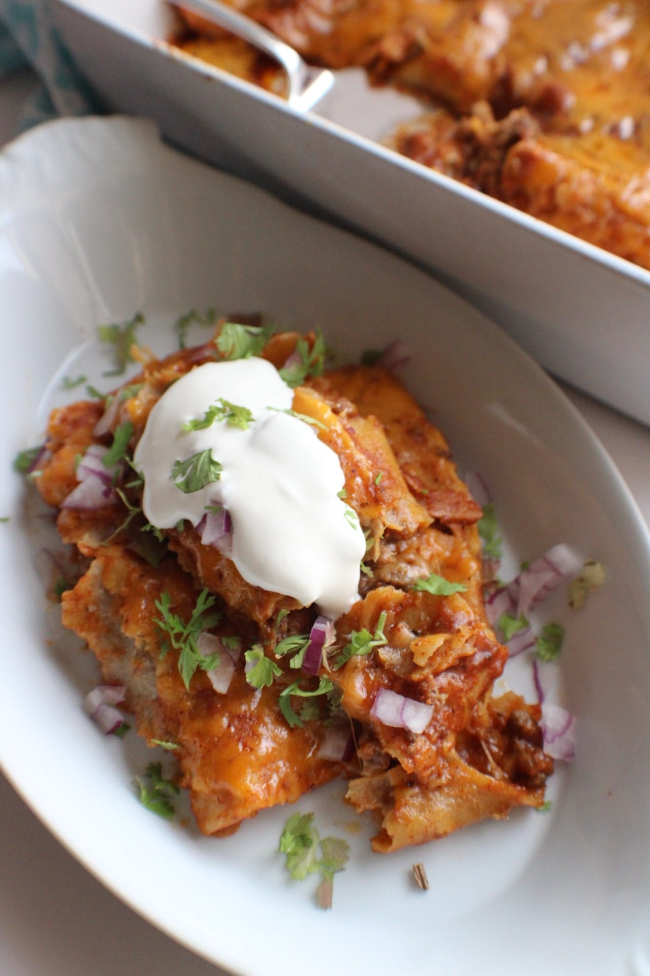 Chorizo Enchiladas plated with a dollop of sour cream on top