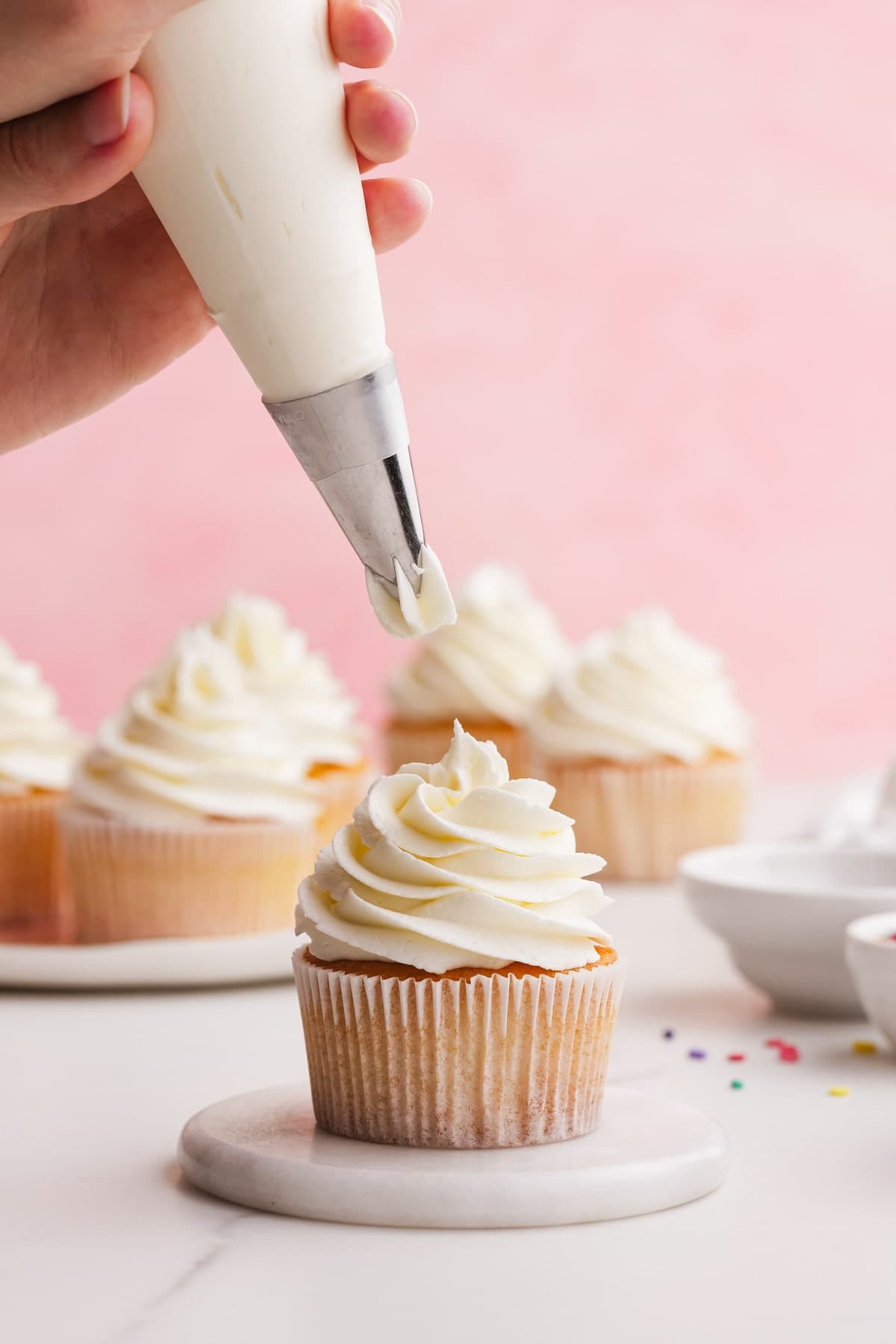 buttercream frosting piped onto a cupcake