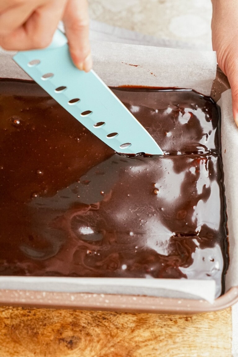 knife cutting brownies in the pan
