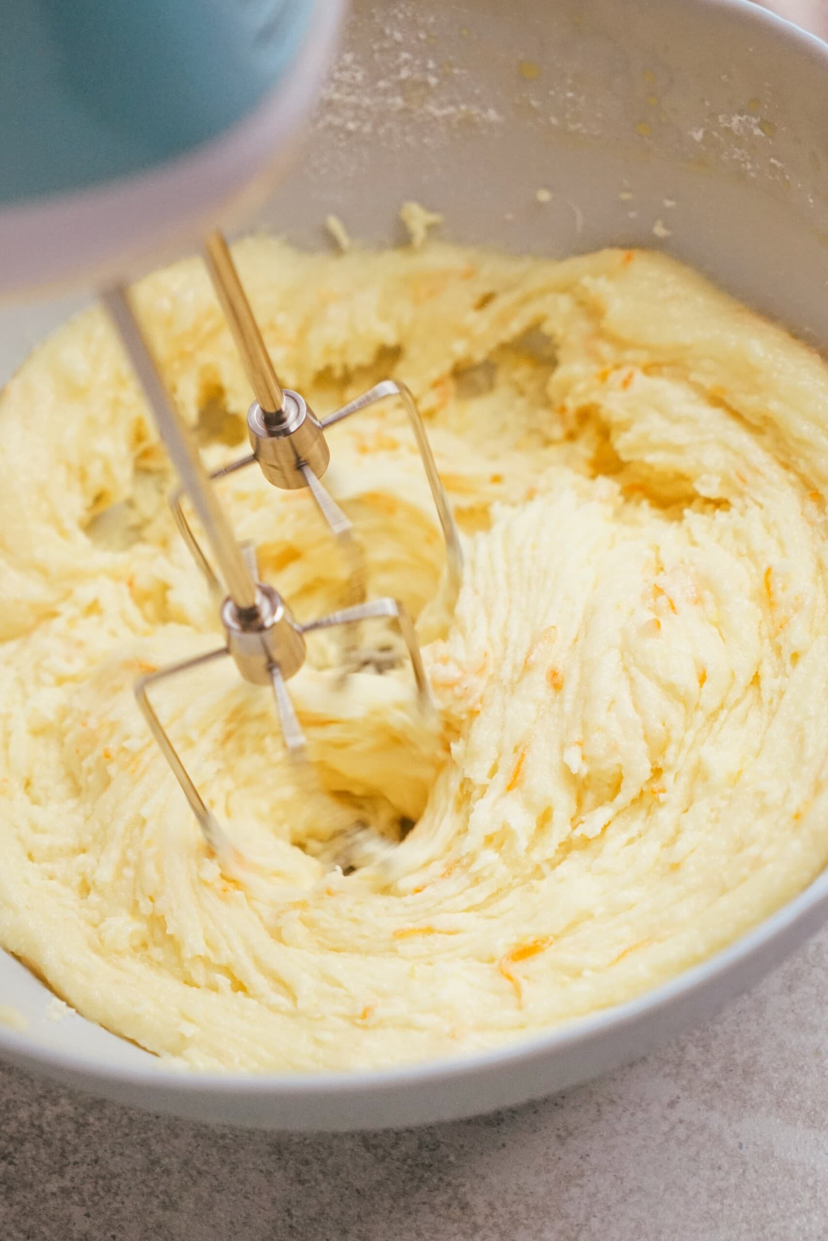 hand mixer beaters mixing orange frosting