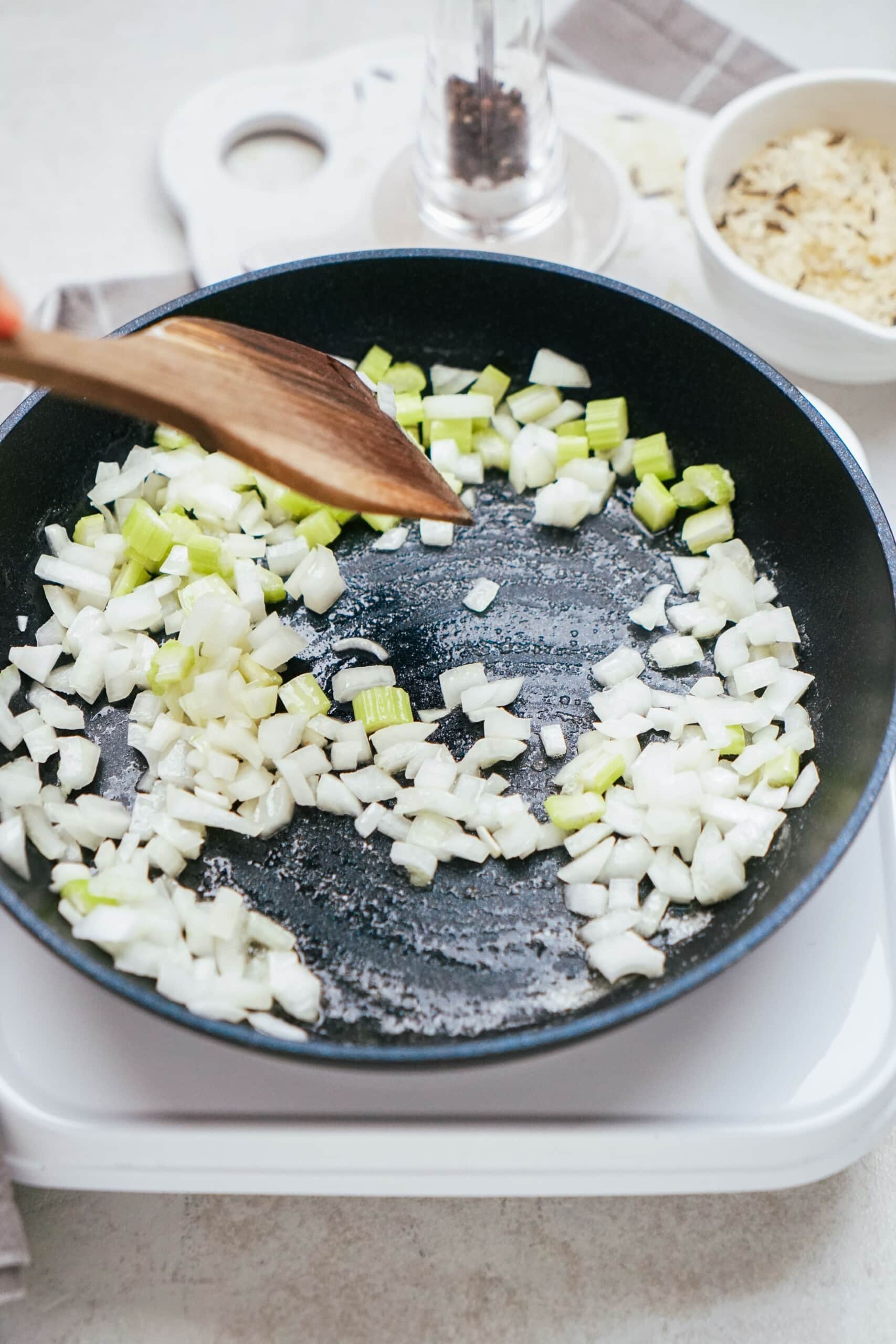 onions and celery sautéed in a skillet