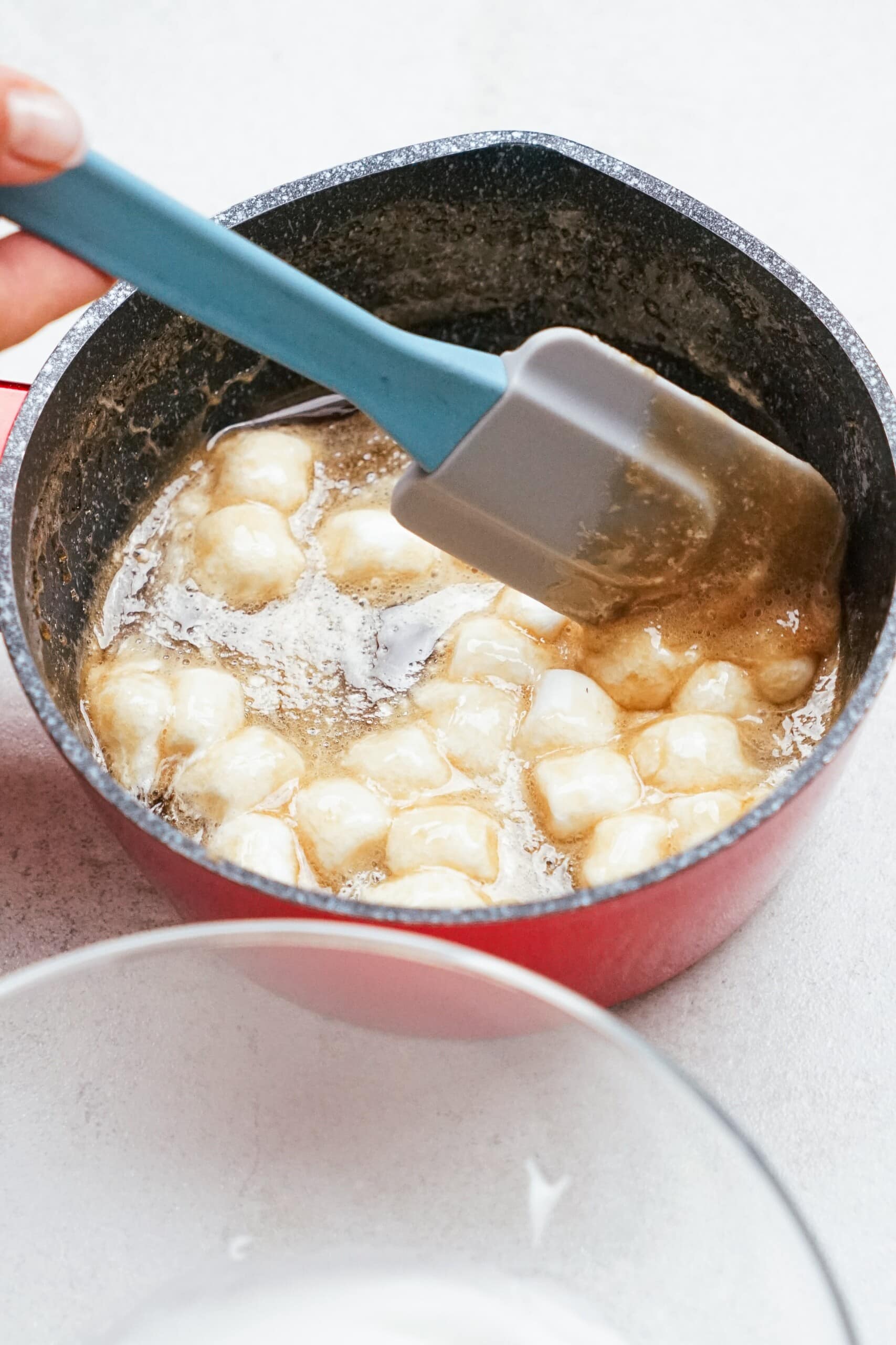 marshmallows melting in hot sugar mixture