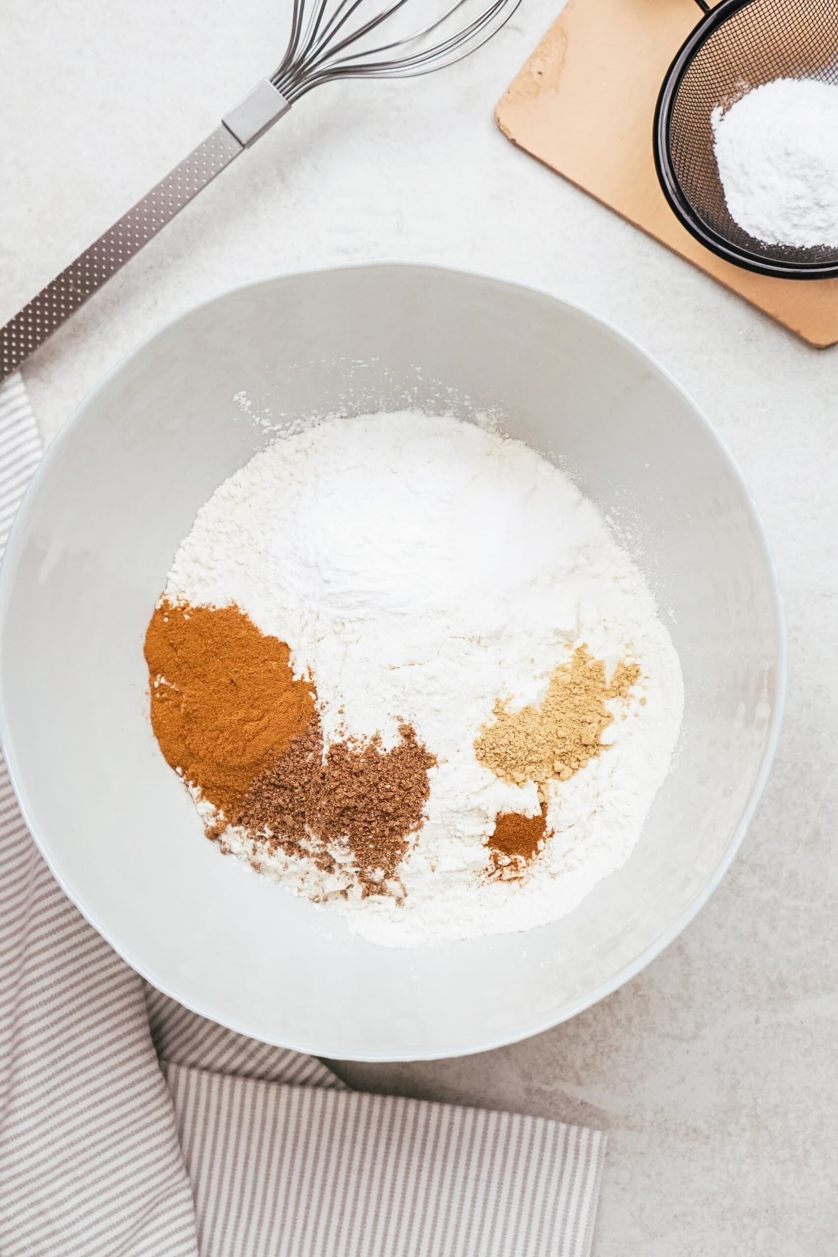 dry ingredients for pumpkin donuts in a mixing bowl