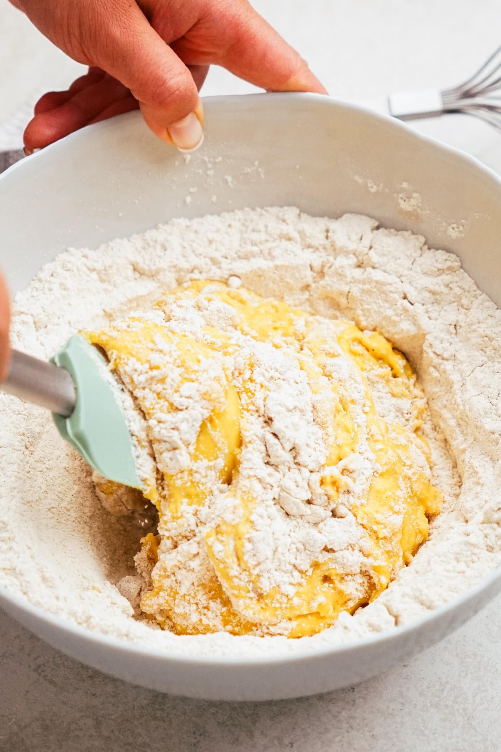 rubber spatula mixing donut ingredients together