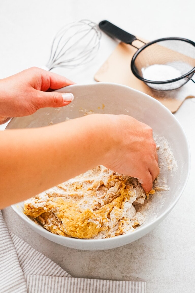 woman's hand mixing donut dough
