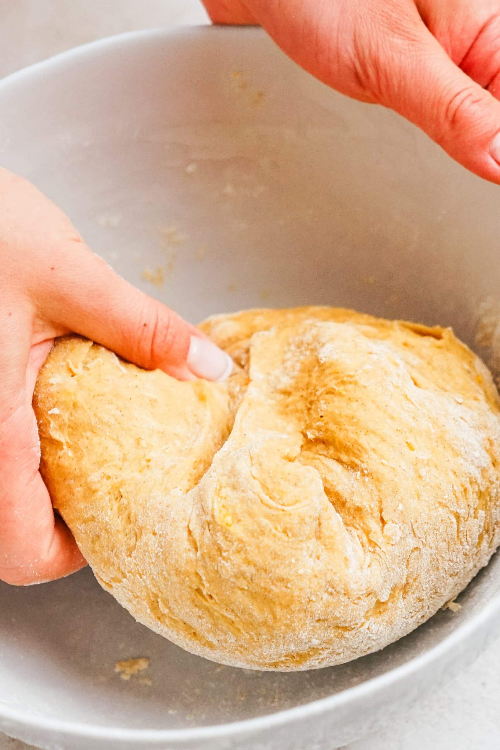 woman's hand forming donut dough