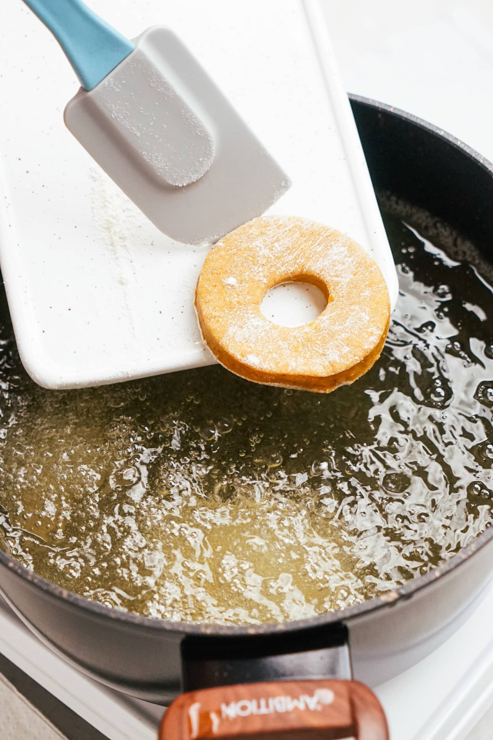 donut being added to the hot oil