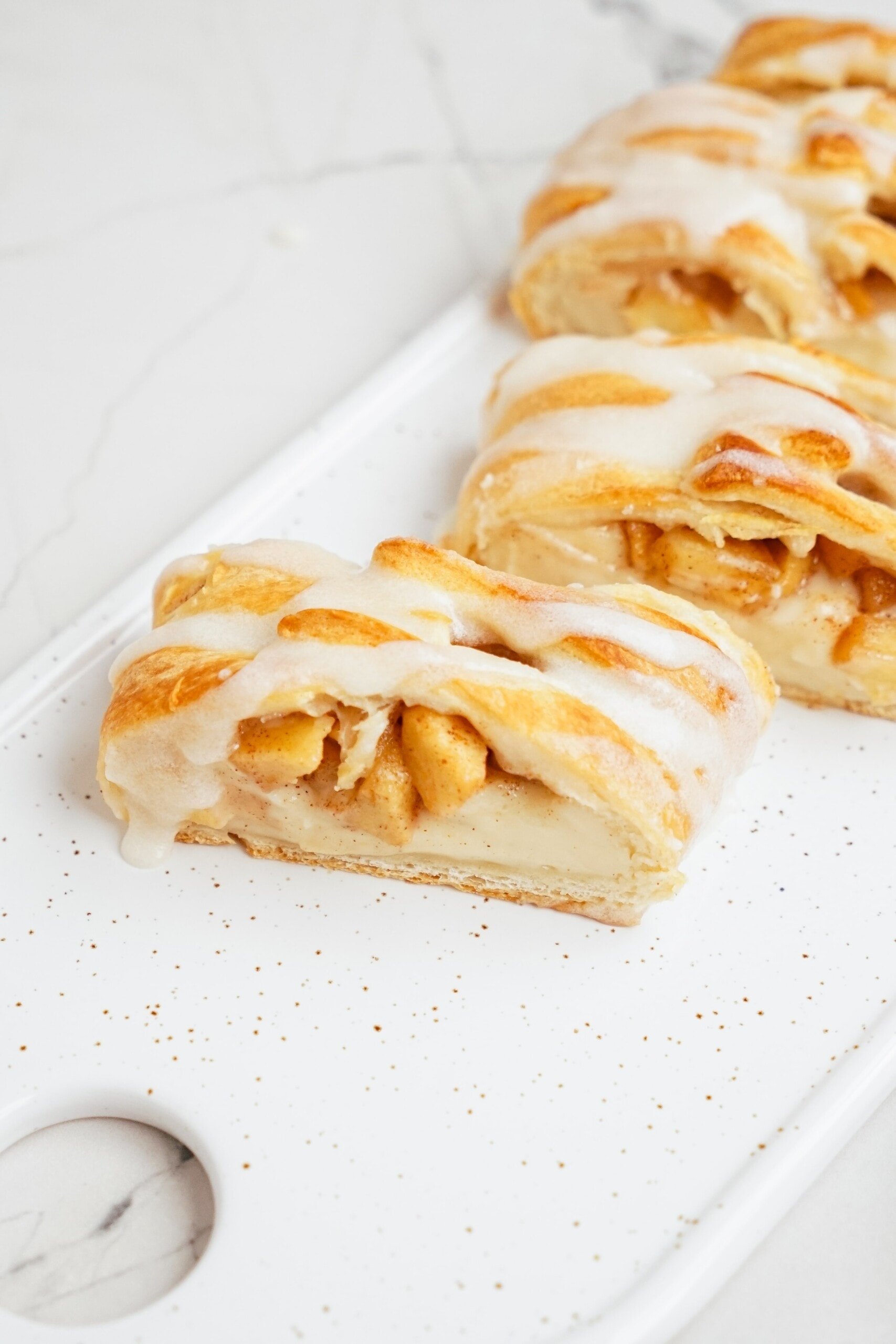 cut apple danish pieces on a serving plate