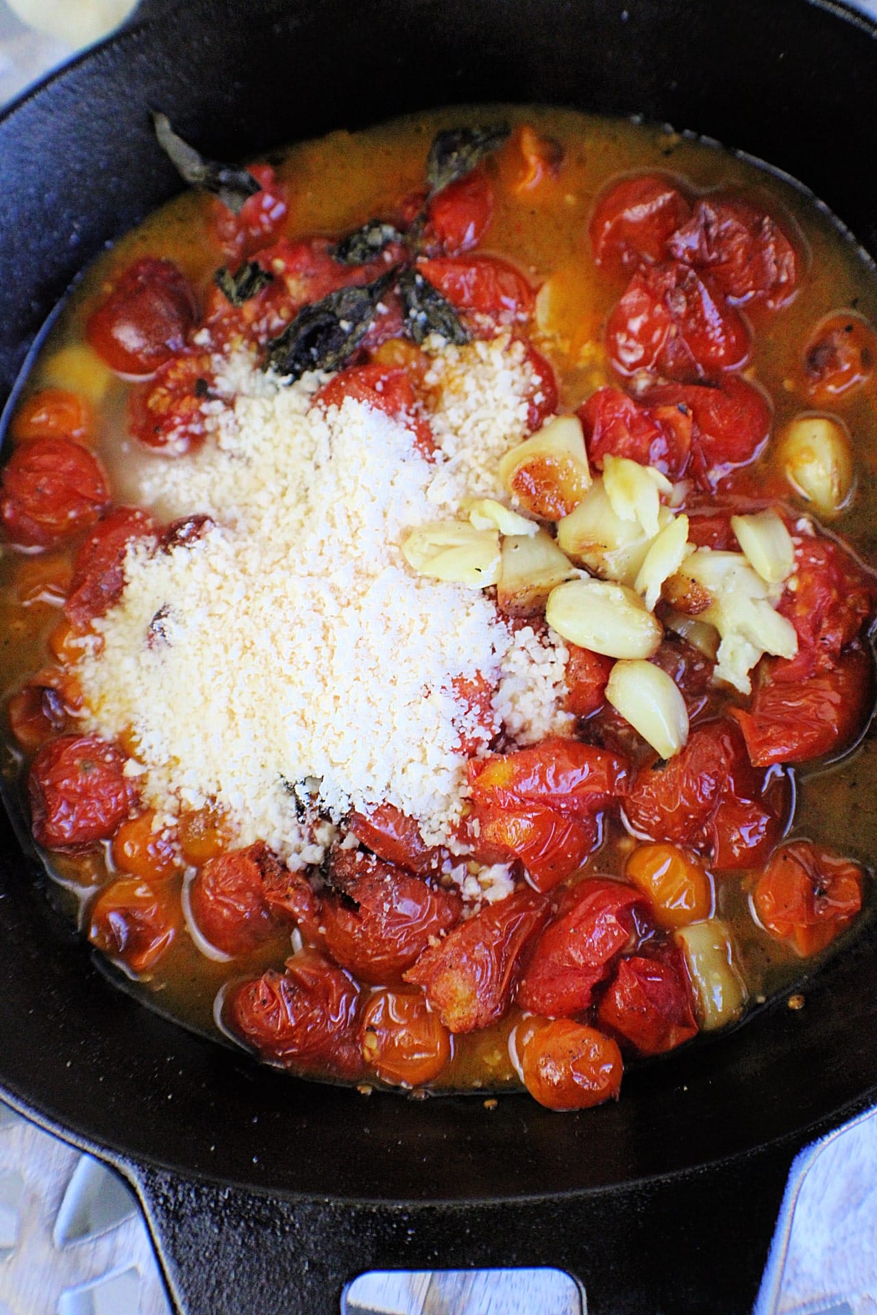 parmesan added to roasted tomatoes and garlic
