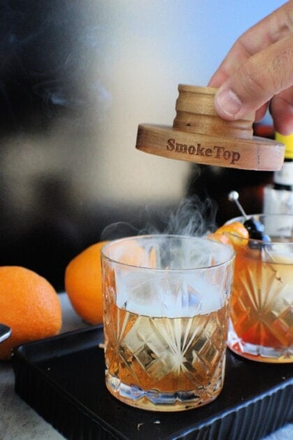 womans hand removing smoker off glass