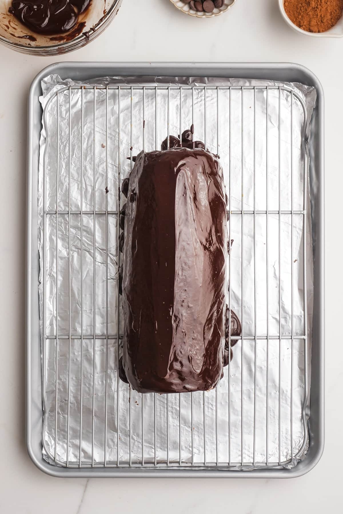 chocolate swiss roll on a baking rack
