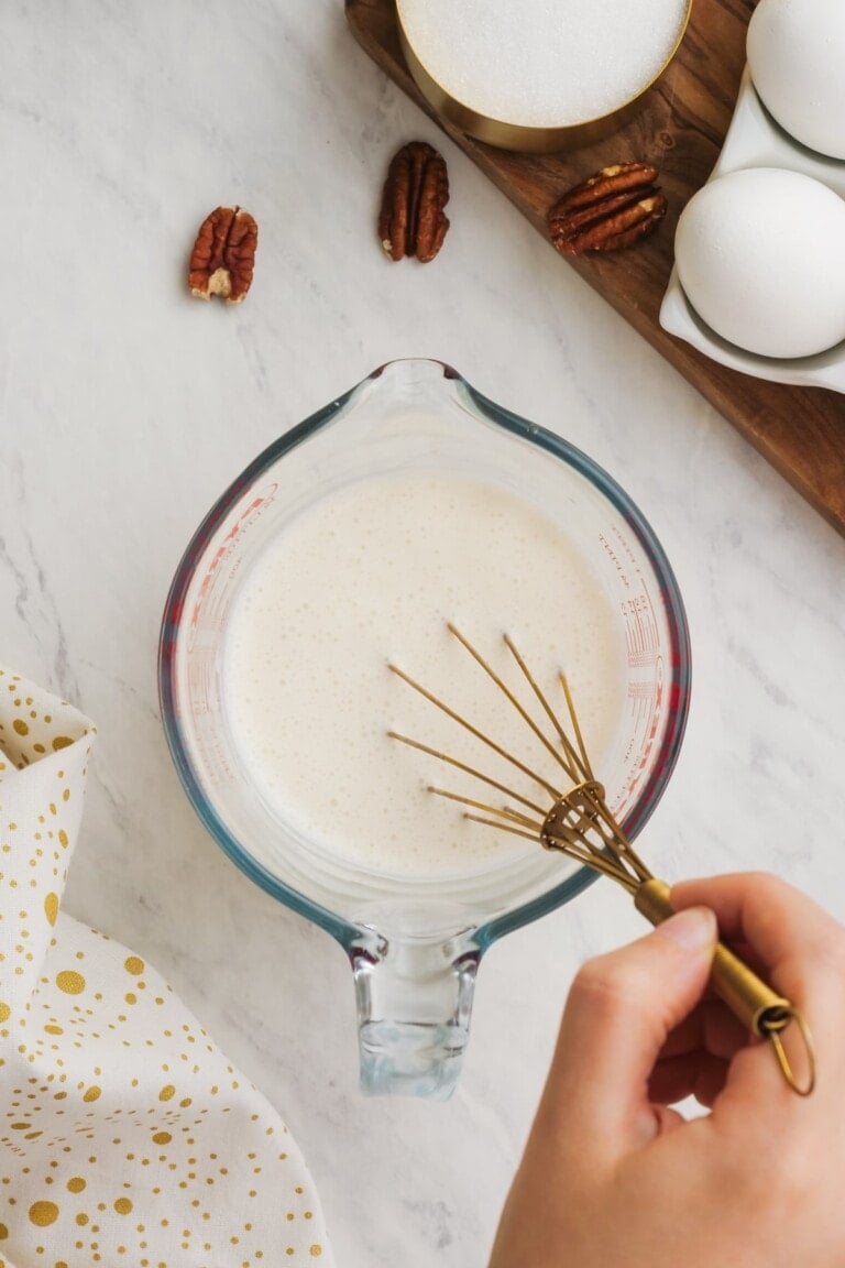 buttermilk in a glass measuring cup with whisk