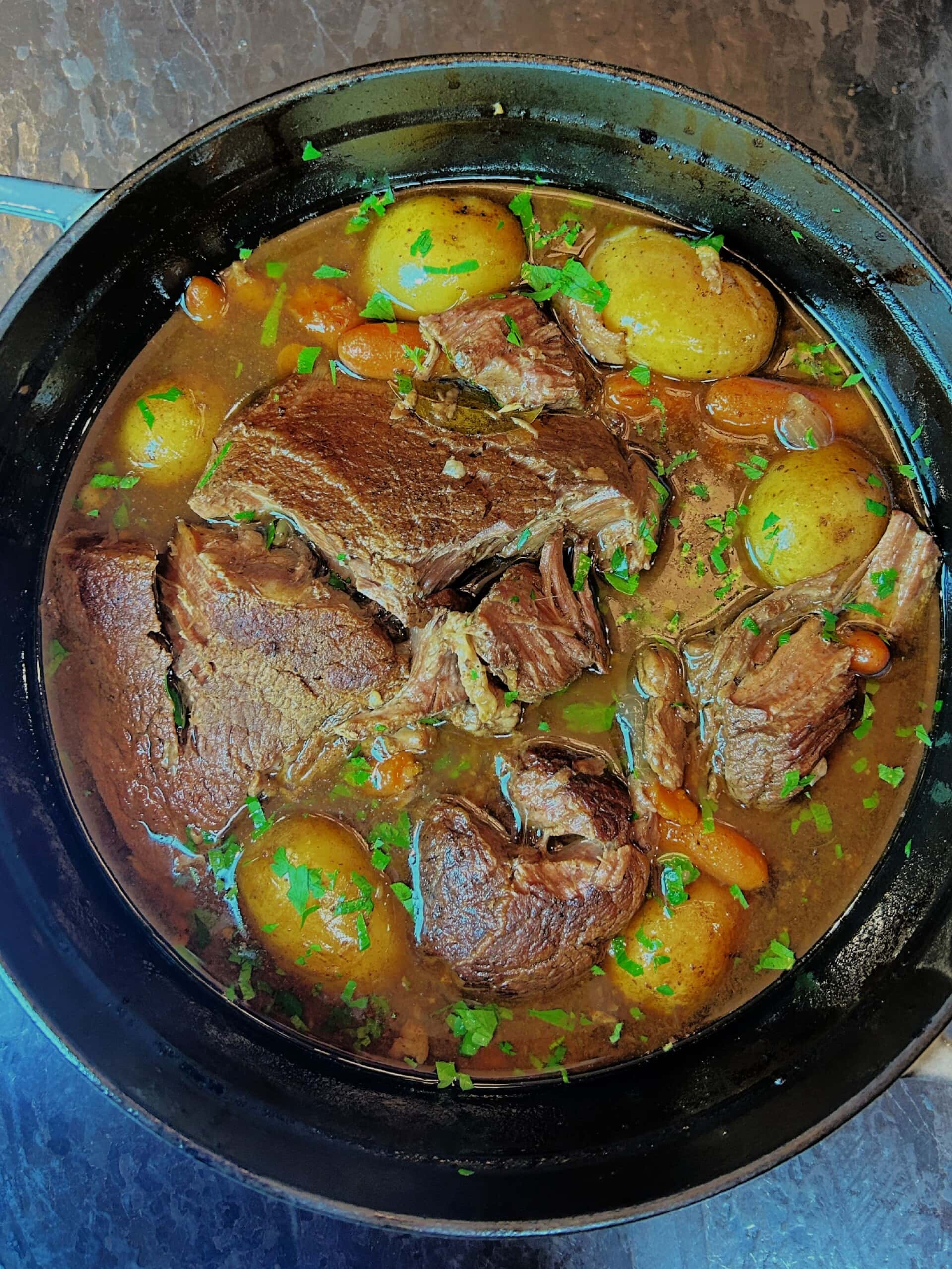 Arm Roast in a large pot with potatoes and veggies