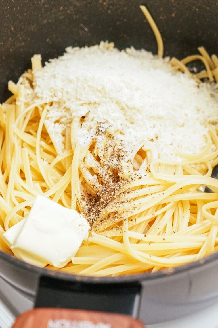 linguine pasta in a pot with butter and cheese