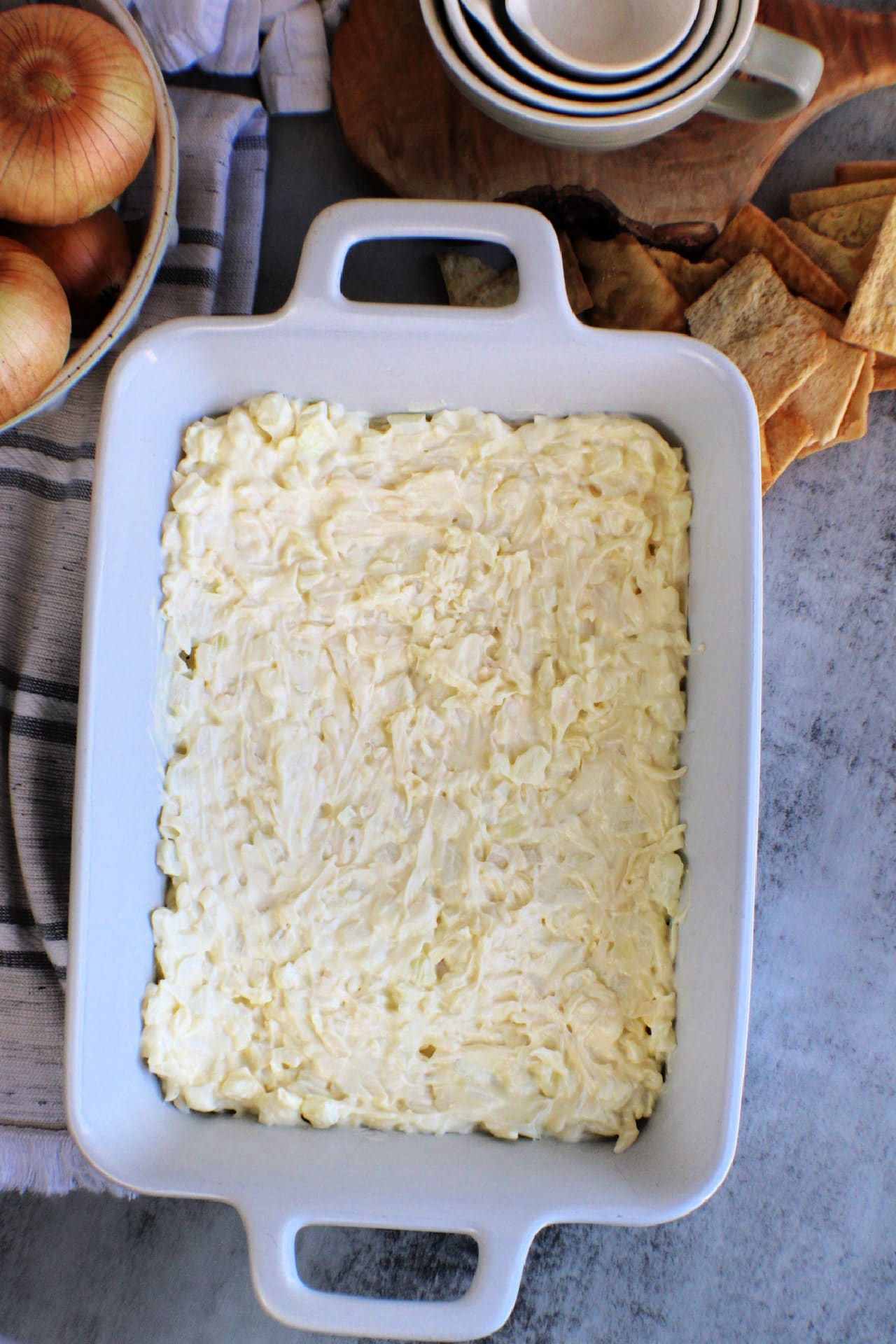 Hot Onion Dip spread into a baking dish