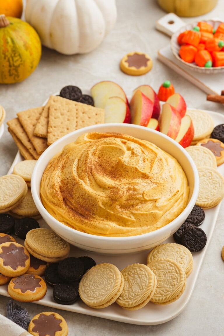 pumpkin dip on a snack board with apples and cookies