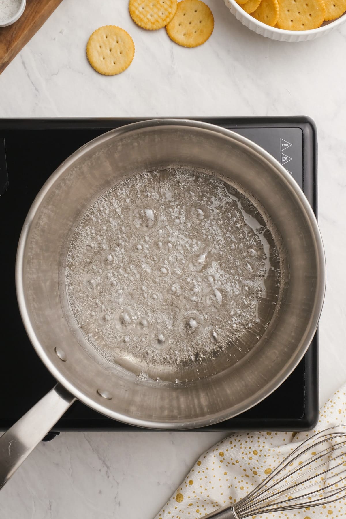 granulated sugar and water boiling in a saucepan