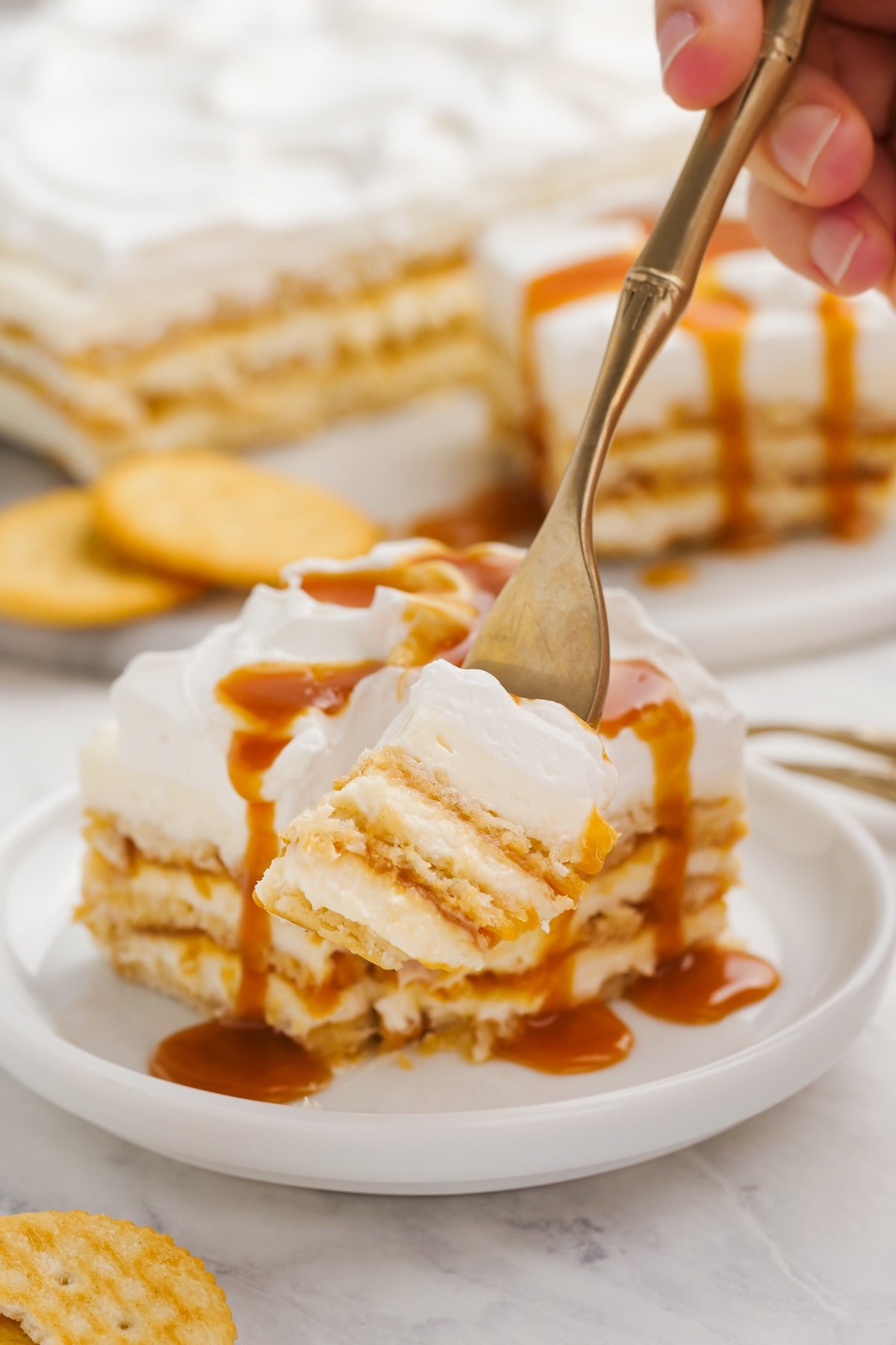 salted caramel ritz cracker icebox cake with a bite on a fork