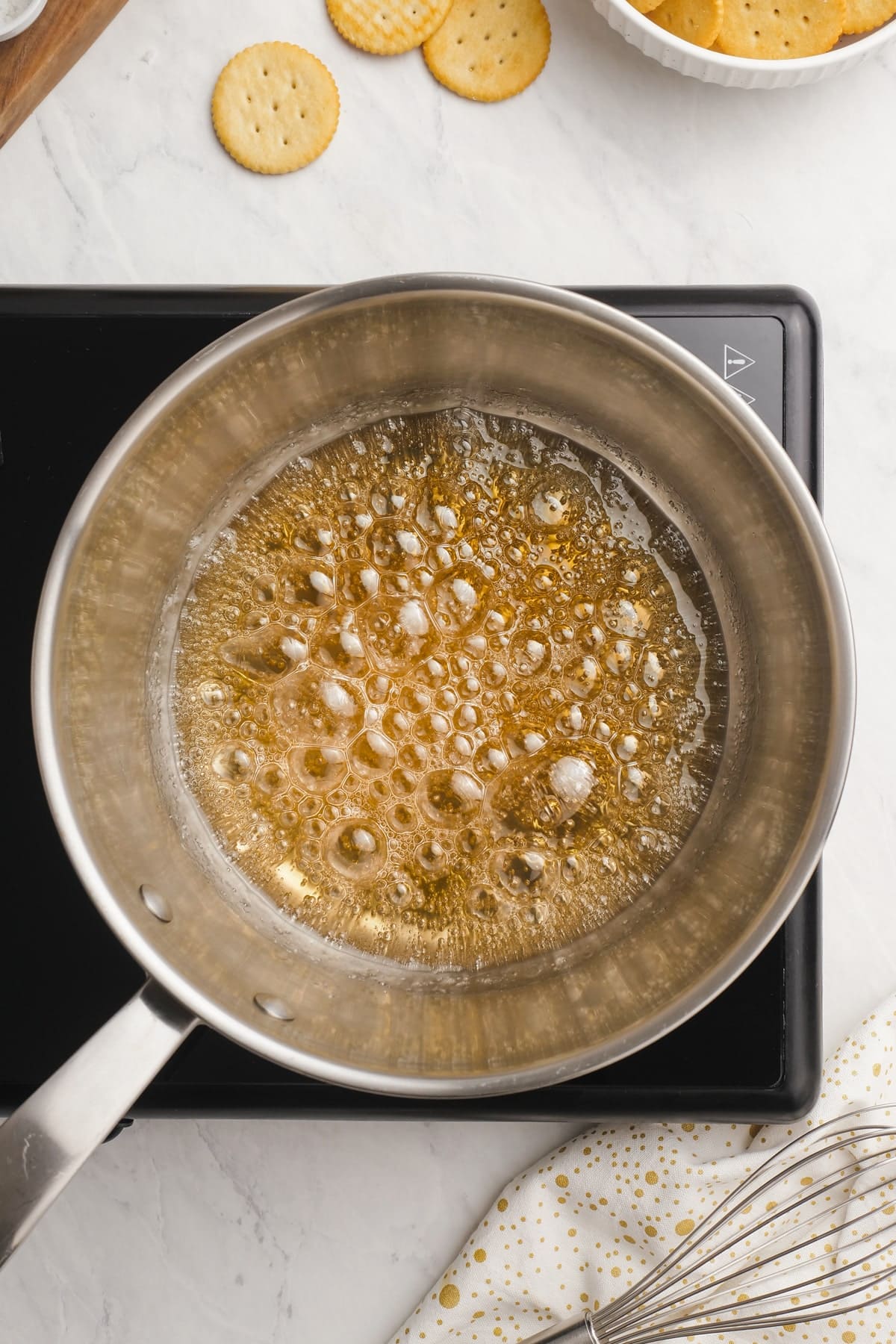 sugar, butter and water turning an amber color in saucepan