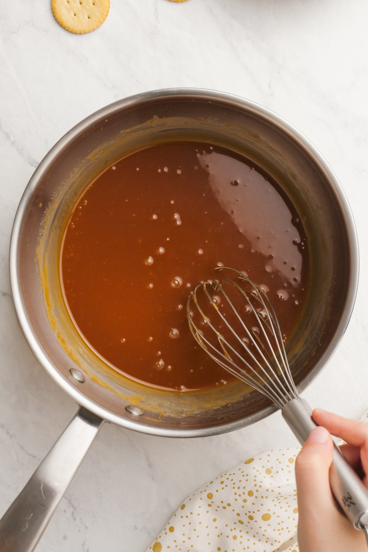 salted caramel sauce in a saucepan with whisk